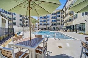 Panama City Beach apartment for rent - Panama City Beach, FL, Apartments Near Pirates Voyage - Vintage Lake Powell - Swimming Pool With Lounge Chairs, Patio Tables, And Large Umbrellas.