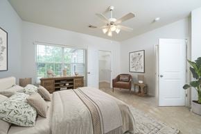 Columbus apartment for rent - A bedroom with a large bed and a ceiling fan.