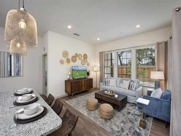 Jacksonville apartment for rent - Pet-Friendly Luxury Apartments in Jacksonville, FL - Terrabella - A Living  Room with a Sofa, Armchair, Coffee Table, and Flat-Screen Television.