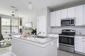 Atlanta apartment for rent - a kitchen with white cabinets and stainless steel appliances