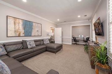 Columbus apartment for rent - A living room with a grey couch and a painting on the wall.