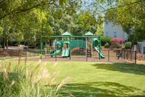Columbus apartment for rent - A playground with a green slide and a green canopy.