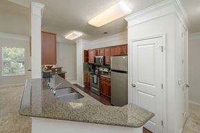 Columbus apartment for rent - A kitchen with brown cabinets and a granite countertop.