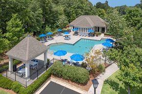 Columbus apartment for rent - A pool surrounded by trees and a gazebo.