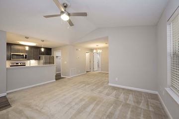 Columbus apartment for rent - A spacious living room with a ceiling fan and lighting fixtures.