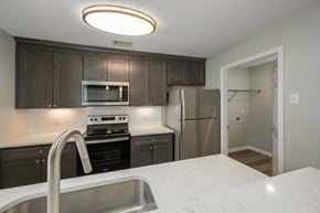 Columbus apartment for rent - A kitchen with a stove, refrigerator, and microwave.