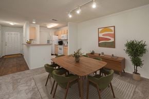 Gulf Breeze apartment for rent - A dining room with a wooden table and green chairs.