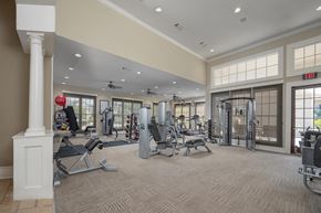 Phenix City apartment for rent - A gym with a variety of equipment including treadmills, weights, and exercise machines.