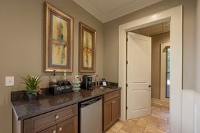 Cumming apartment for rent - A kitchen with brown cabinets and a black counter top.