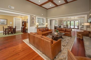 Knoxville apartment for rent - A large brown leather couch sits in the middle of a spacious living room.