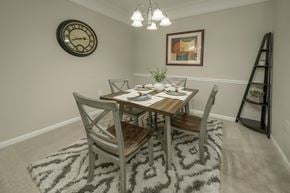 Knoxville apartment for rent - A dining room with a table set for two and a clock on the wall.