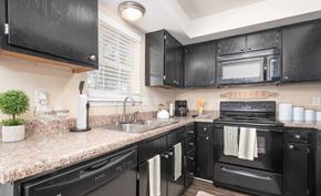Athens townhouse for rent - A black kitchen with granite countertops and a black oven.