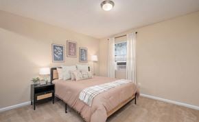 Athens townhouse for rent - A bedroom with a bed, nightstand, and pictures on the wall.