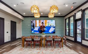 Lewisville apartment for rent - a dining room with a table and chairs and a tv on the wall