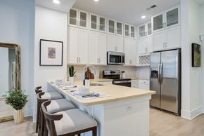 Huntersville apartment for rent - A kitchen with a table and chairs and a fridge.
