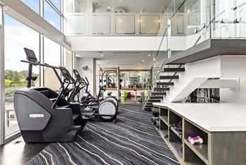 Two-story fitness center with trx® training equipment, multi-use studios, and yoga/pilates areas