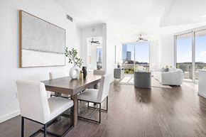 Atlanta apartment for rent - A modern dining room with a wooden table and white chairs.