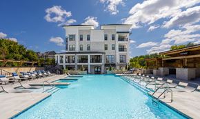 Franklin apartment for rent - A large swimming pool in front of a multi-story building.