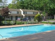 Midland apartment for rent - A pool with a diving board in front of a house.