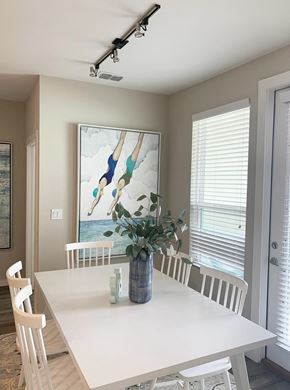 Pensacola apartment for rent - a dining room with a table and chairs and a painting on the wall