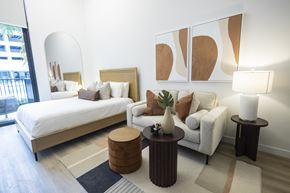 Ft Lauderdale apartment for rent - A modern bedroom with a large bed and a white couch.
