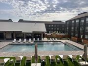 Rogers apartment for rent - an outdoor pool with chairs and a building