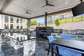 Knoxville apartment for rent - A modern outdoor kitchen with a stone counter and a grill.