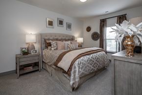 Murfreesboro apartment for rent - Dog-Friendly Luxury Apartments in Murfreesboro, TN - Vintage Blackman - Bedroom with Matching Bedside Tables with Lamps and a Window.