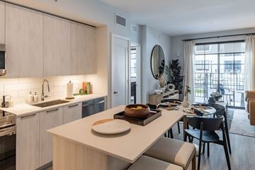 Plantation apartment for rent - an open kitchen and living room with a dining room table and a living room