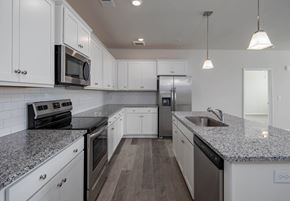 Cane Ridge apartment for rent - a kitchen with white cabinets and gray countertops