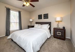 Lafayette apartment for rent - A bedroom with a large bed and a ceiling fan.