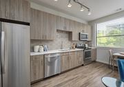 Atlanta apartment for rent - A modern kitchen with wooden cabinets and stainless steel appliances.