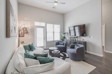 Mount Pleasant apartment for rent - A living room with a white couch and a grey armchair.