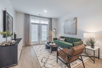 Summerville apartment for rent - A living room with a green couch and a brown leather chair.
