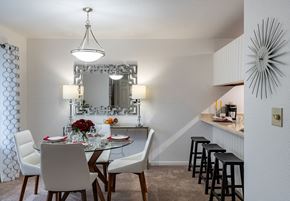 Saginaw apartment for rent - a dining area with a glass table and white chairs  at Pheasant Run, Saginaw, Michigan