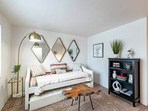 Saginaw apartment for rent - a bedroom with a bed and a bookshelf  at Pheasant Run, Saginaw, Michigan