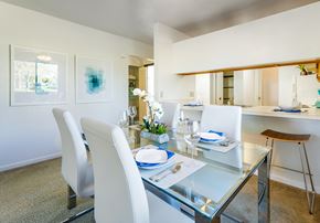 Saginaw triplex for rent - a dining area with a glass table and white chairs