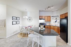 North Charleston apartment for rent - a kitchen with a bar and a dining table with chairs