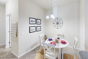 North Charleston apartment for rent - a dining room with a white table and chairs