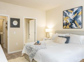 North Charleston apartment for rent - a bedroom with a white bed and a painting on the wall