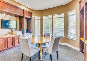 Cleveland apartment for rent - a conference room with a table and chairs and a television