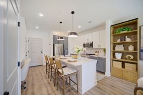 Panama City Beach apartment for rent - Panama City Beach, FL, Apartments Near Pier Park - Vintage Lake Powell - Kitchen With Large White Island, Bar Seating, Pendant Lights, White And Gray Cabinets, And Stainless Steel Appliances.