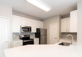 Alpharetta apartment for rent - a kitchen with white cabinets and a white counter top