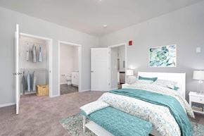 Jeffersonville apartment for rent - 2 Bedroom Luxury Apartments In Jeffersonville, IN - The Laurel - Bedroom With Plush Carpet, Walk-In Closet, Modern Décor, and Attached Bathroom.