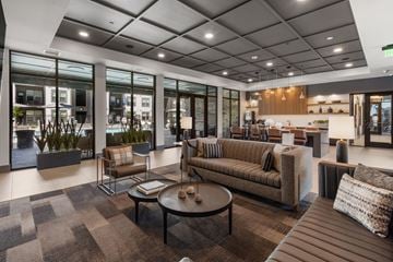 Bozeman apartment for rent - A modern living room with a brown sofa and a coffee table.