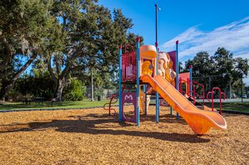 A playground with a slide and a climbing frame