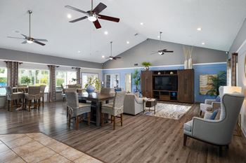 A living room with a wooden floor and a ceiling fans