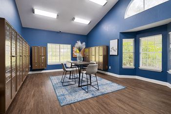 A dining room with a table and chairs