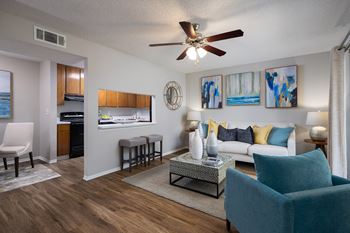 A living room with a blue chair and a white couch