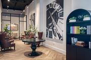 Tampa apartment for rent - A large clock is on the wall behind a table.